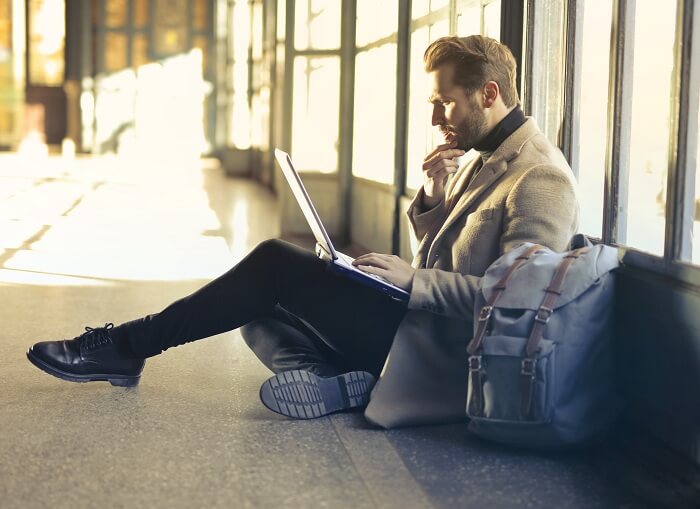 Man on laptop at airport